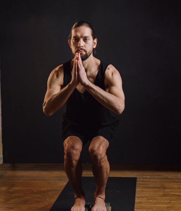 Man practicing a calming exercise with focus and strength.